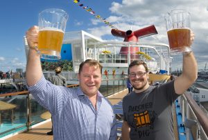 President of Beverage Operations Edward Allen, left, and Brewmaster Colin Presby, right, hoist pitchers filled with craft beers. Photo: Andy Newman/Carnival Cruise