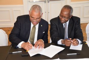 Carnival Corporation President Arnold Donald and Prime Minister the Right Honourable Perry G. Christie sign the agreement