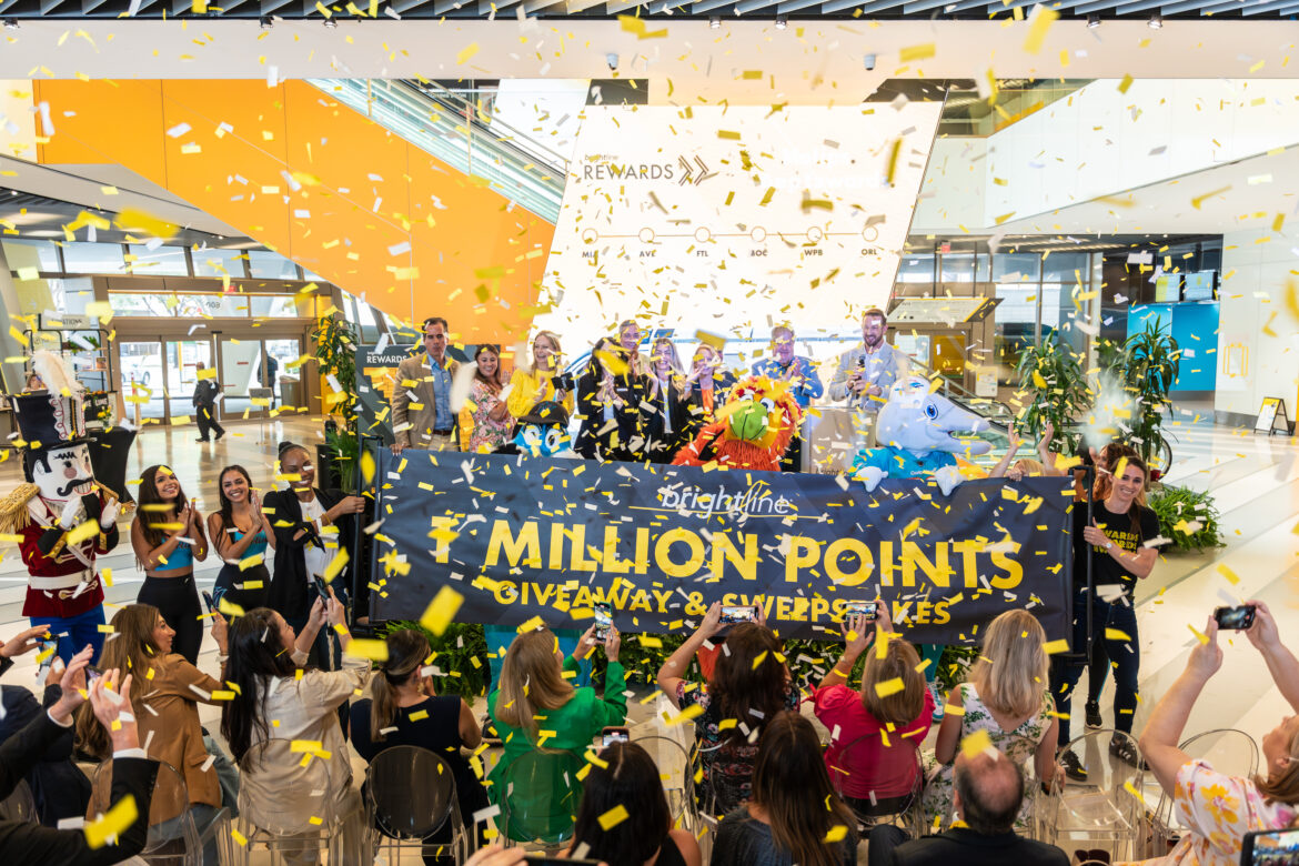 Confetti falls on a throng of people in MiamiCentral Station as Brightline announces a One Million-Point Giveaway and Sweepstakes to launch their new loyalty program.