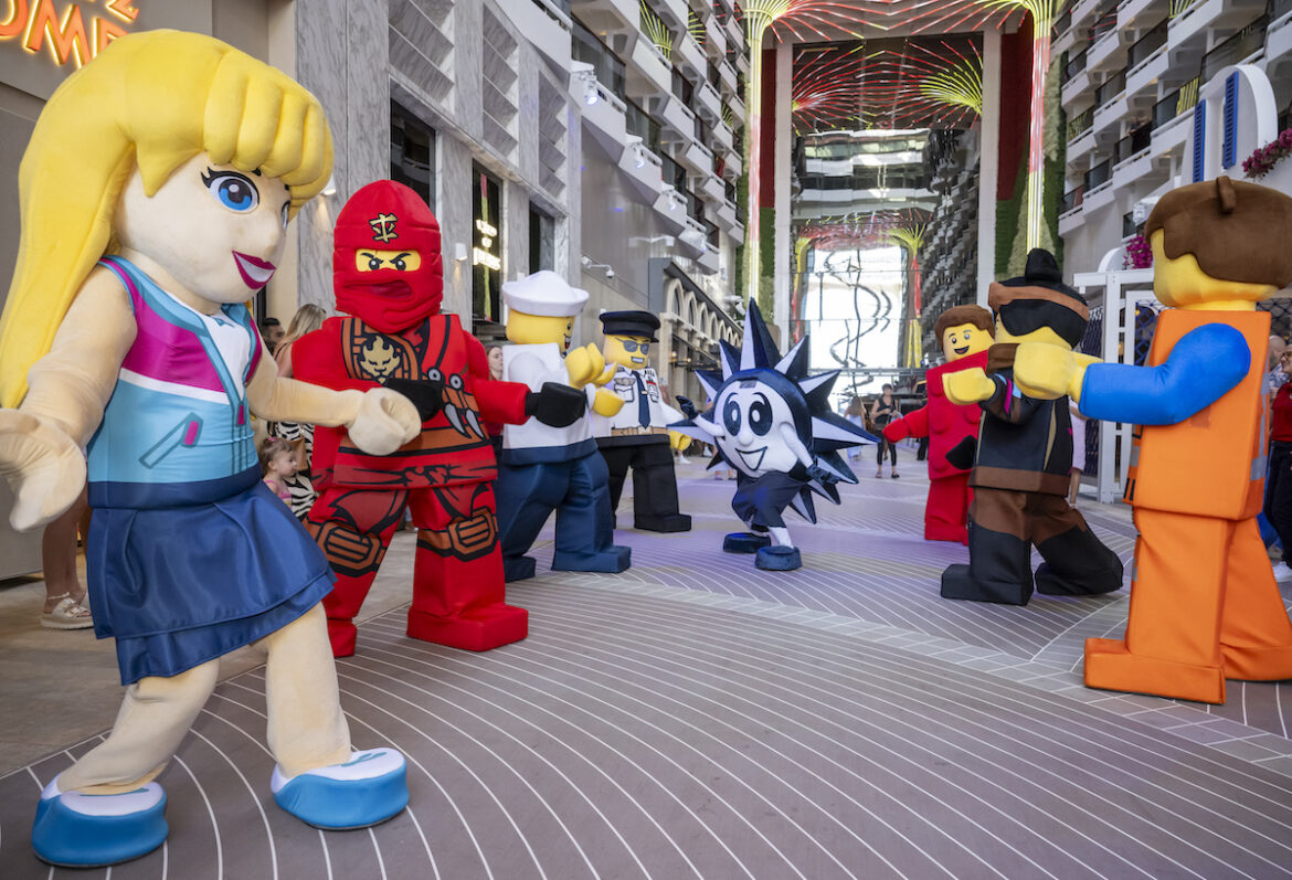 Costumed characters assemble on the deck of MSC World America for the LEGO Family Parade.