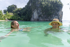 Two women swimming in Southeast Asia's karst islands.