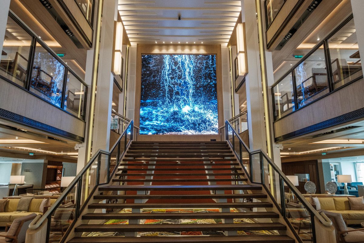 Stairs and large video screen inside the Atrium on-board the Viking Sea